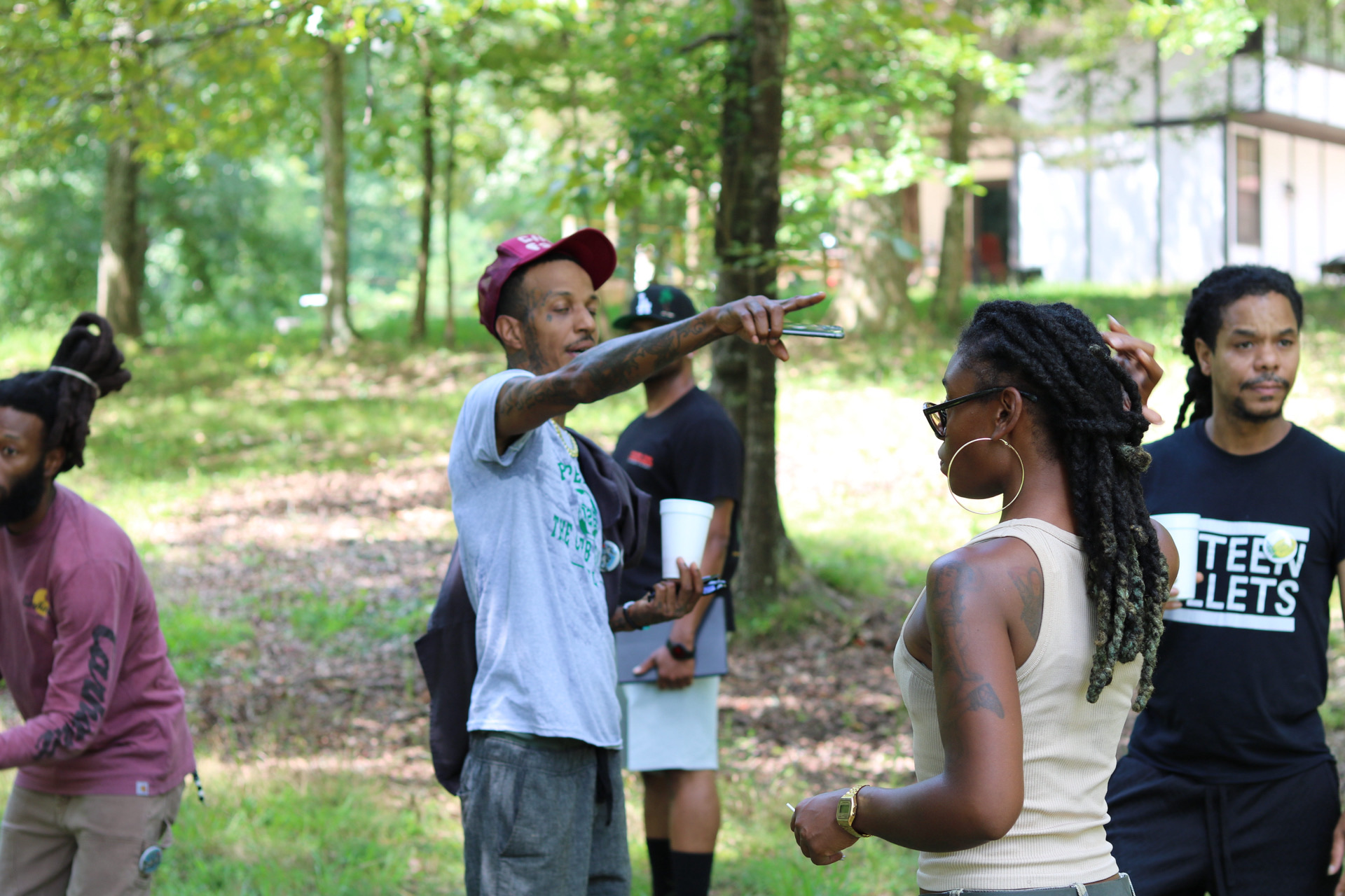 Volunteers gathering outdoors among the trees at CHACE Farms